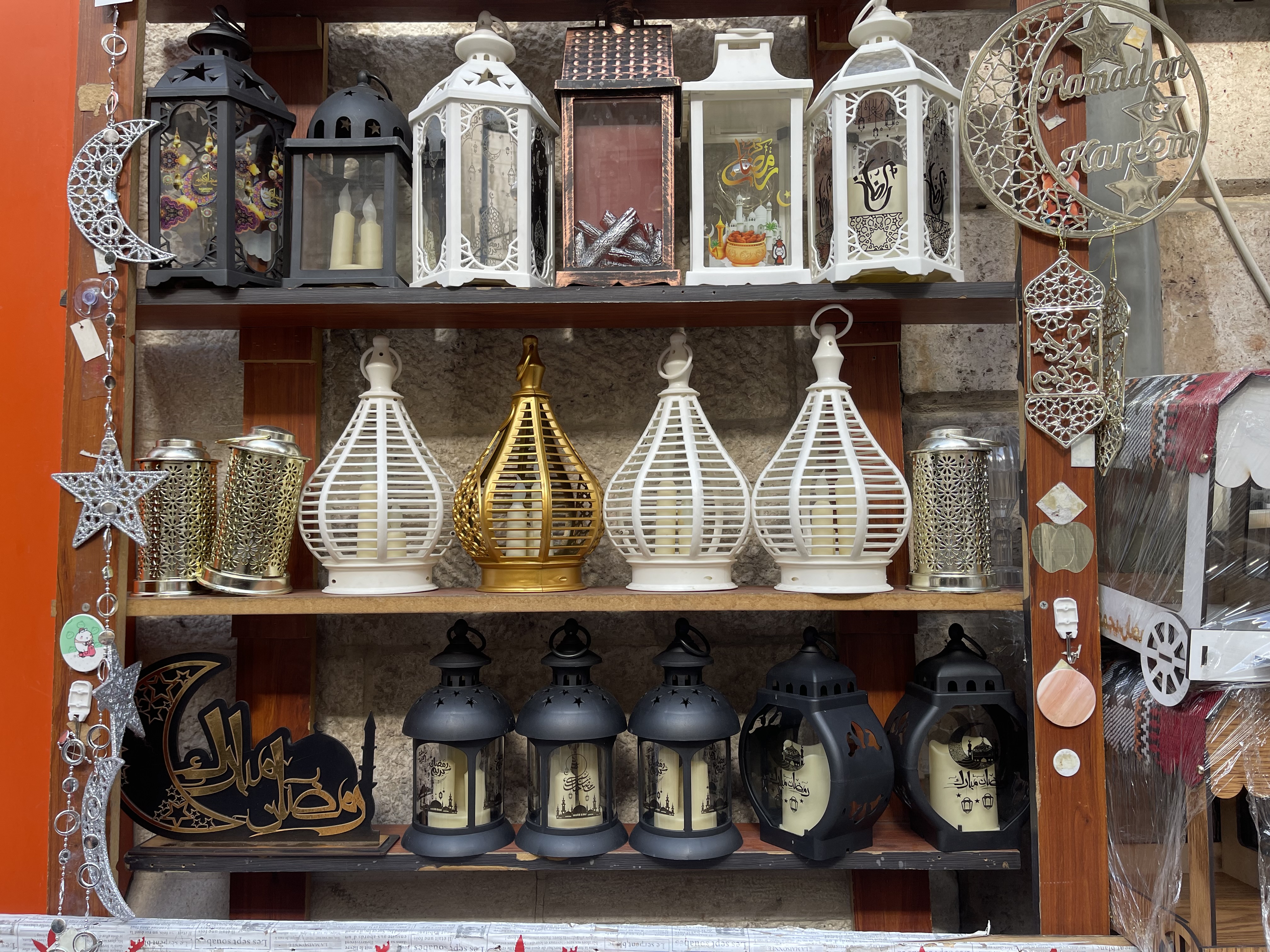 Shelves of decorative lanterns in white, gold and black for sale during Ramadan